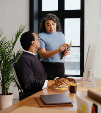 two employees communicating in an office setting